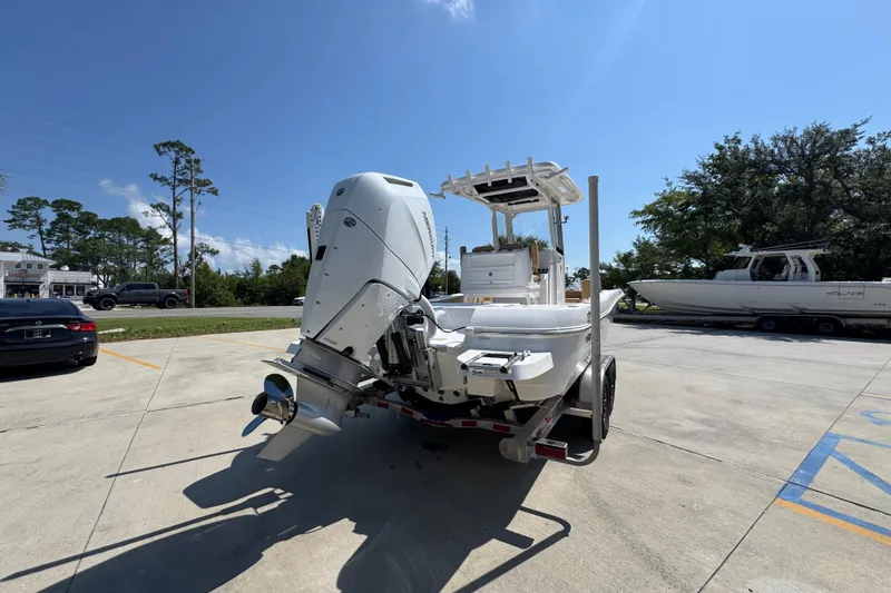 Slide: The Image of 2027 Caymas 26 HB boat on trailer, parked outdoors under clear blue sky. - 14