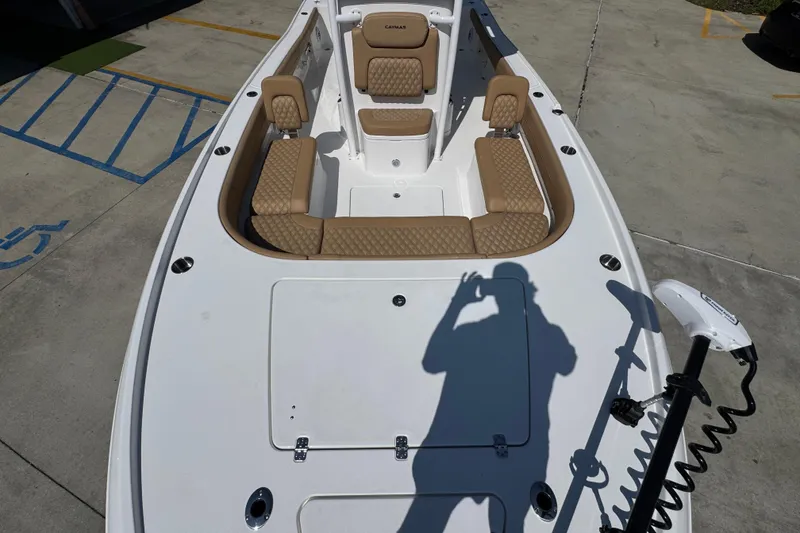 Slide: The Image of 2027 Caymas 26 HB boat interior with tan seating and fishing equipment. - 23
