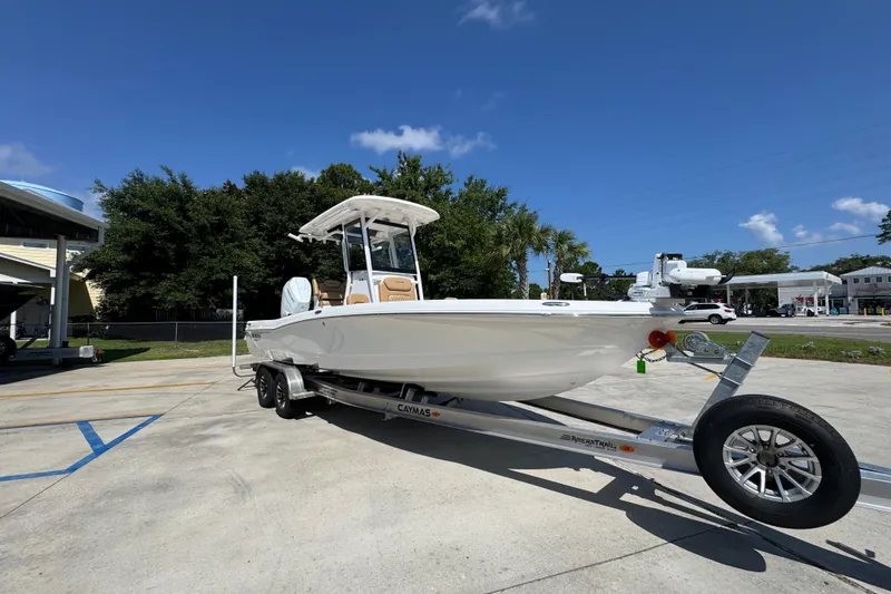 Slide: The Image of 2027 Caymas 26 HB boat on trailer under clear blue sky. - 8