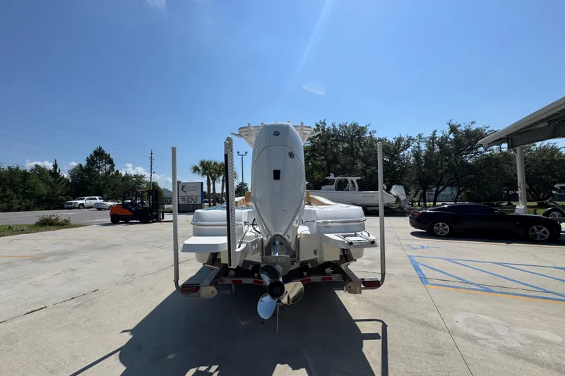 Slide: The Image of 2027 Caymas 26 HB boat on trailer in sunny outdoor setting. - 15