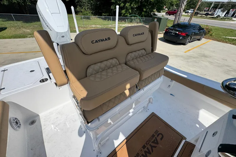 Slide: The Image of 2027 Caymas 26 HB boat with tan cushioned seating and white deck. - 31