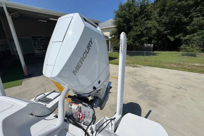Slide: The Image of 2027 Caymas 26 HB boat with Mercury engine and Power-Pole, parked outdoors. - 42