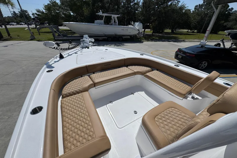 Slide: The Image of 2027 Caymas 26 HB boat with luxurious tan seating and spacious deck layout. - 21