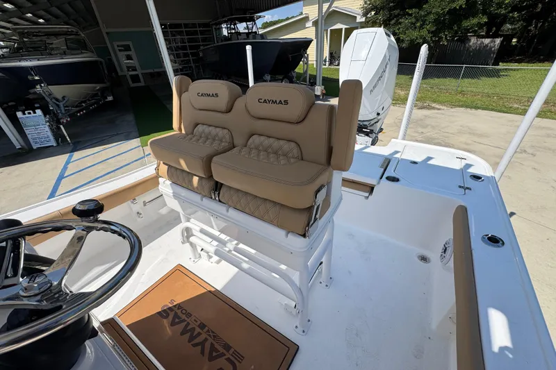 Slide: The Image of 2027 Caymas 26 HB boat interior with tan seating and steering wheel. - 29