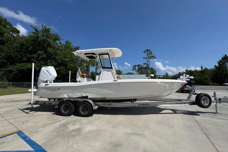 Slide: The Image of 2027 Caymas 26 HB boat on trailer, parked outdoors under clear blue sky. - 10