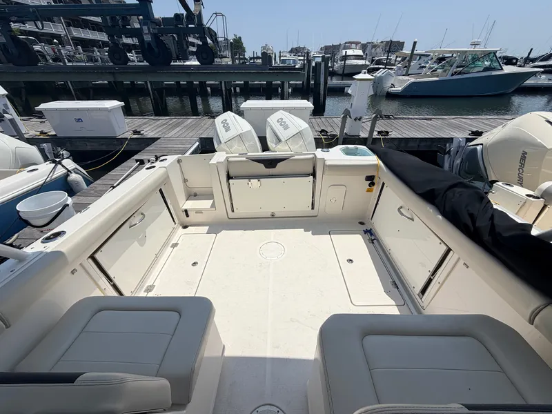 Slide: The Image of The image shows the cockpit of a 2022 Sailfish 276 DC with dual engines at the dock. - 22