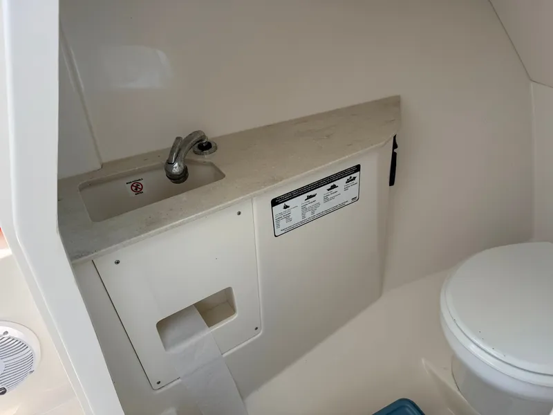 Slide: The Image of The image shows the bathroom of a 2022 Sailfish 276 DC with a sink and toilet. - 13