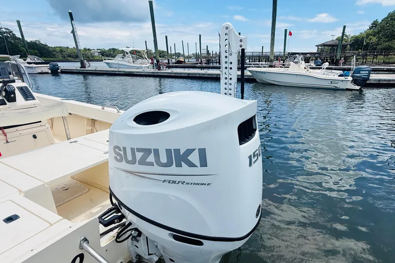 Slide: The Image of Jones Brothers Cape Fisherman 1910 boat with Suzuki 150 outboard at marina. - 4