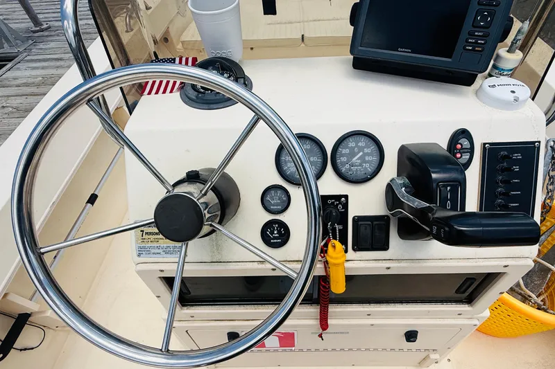Slide: The Image of Jones Brothers Cape Fisherman 1910 boat dashboard with steering wheel and controls, year 2000 model. - 9