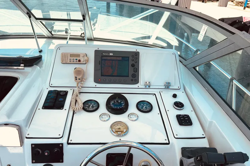 Slide: The Image of 1994 Pro-Line 2950 Walkaround boat dashboard with navigation equipment and controls. - 9
