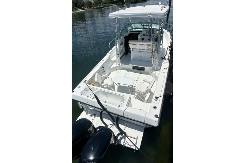 Slide: The Image of 1994 Pro-Line 2950 Walkaround boat with spacious deck and dual outboard motors. - 2