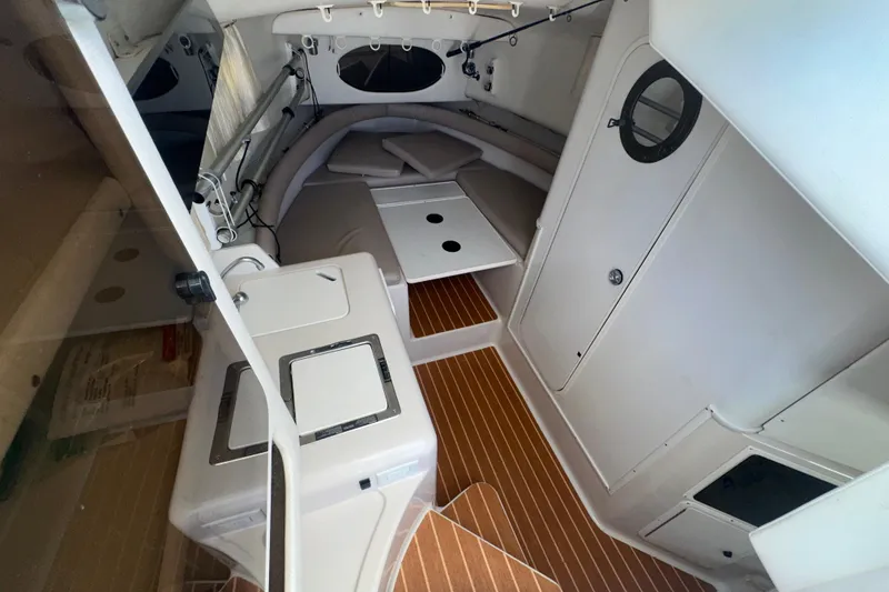 Slide: The Image of 1994 Pro-Line 2950 Walkaround cabin interior with wood flooring and compact amenities. - 5
