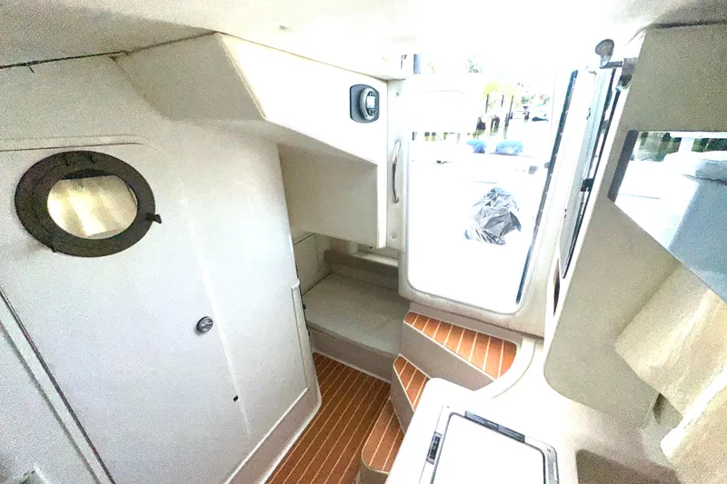 Slide: The Image of Interior of 1994 Pro-Line 2950 Walkaround boat with wooden steps and porthole window. - 4