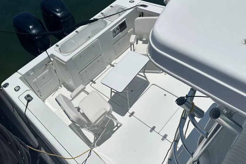 Slide: The Image of 1994 Pro-Line 2950 Walkaround boat deck with seating and table setup. - 3