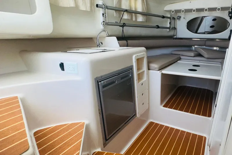Slide: The Image of 1994 Pro-Line 2950 Walkaround cabin interior with kitchenette and seating area. - 11
