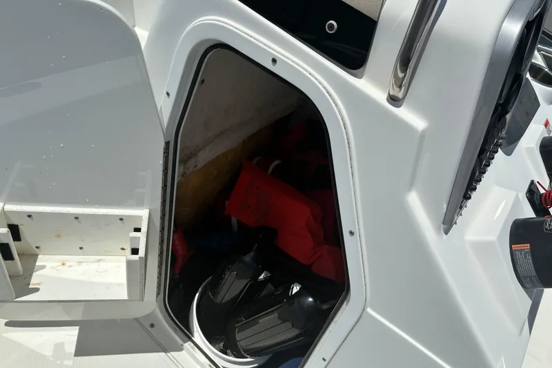 Slide: The Image of Storage compartment of 2014 Sea Hunt BX 20 BR boat with life jackets and gear. - 10