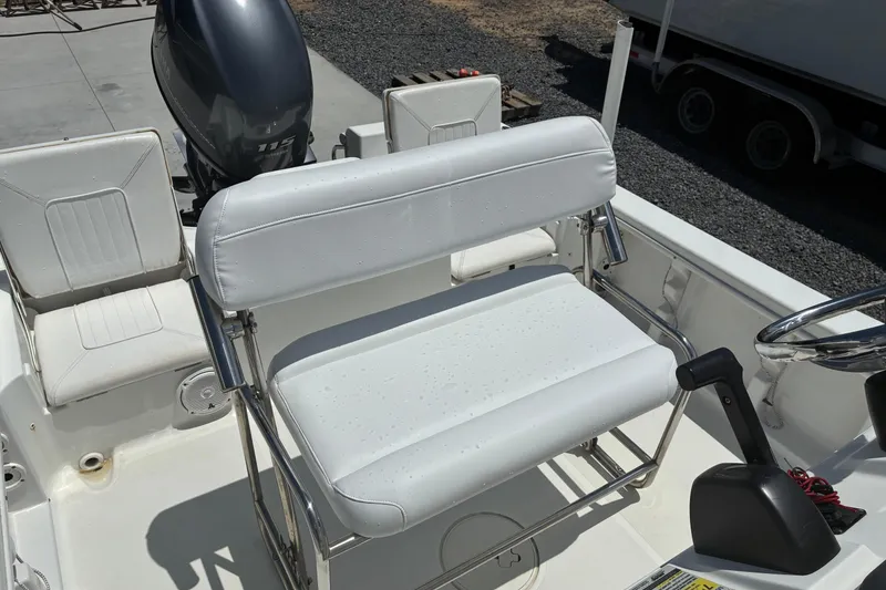 Slide: The Image of 2014 Sea Hunt BX 20 BR boat interior with white seating and steering console. - 5