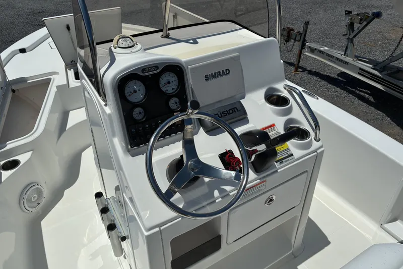Slide: The Image of 2014 Sea Hunt BX 20 BR boat console with steering wheel and navigation equipment. - 11