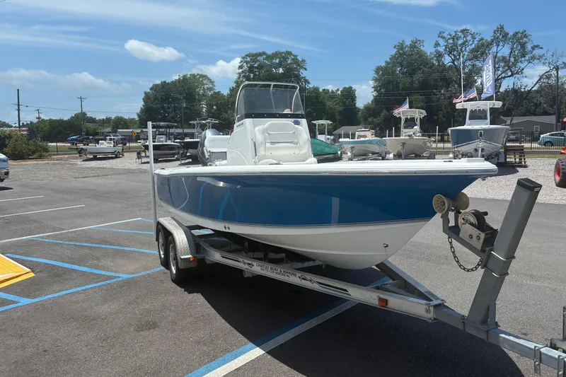 Slide: The Image of 2014 Sea Hunt BX 20 BR boat on trailer in parking lot under clear sky. - 2