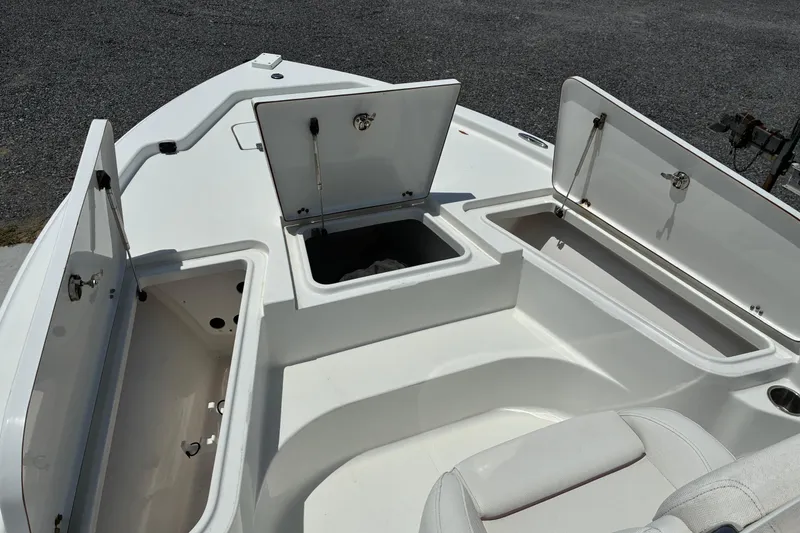 Slide: The Image of 2014 Sea Hunt BX 20 BR boat with open storage compartments on deck. - 14