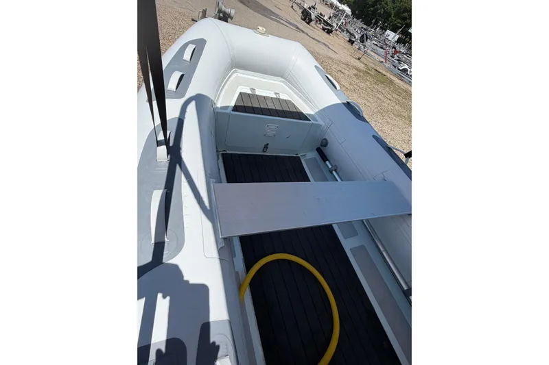 Slide: The Image of 2022 Achilles inflatable boat interior with seating and floor details. - 7
