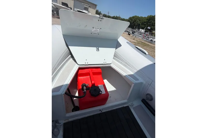 Slide: The Image of 2022 Achilles inflatable boat storage compartment with red fuel tank. - 3
