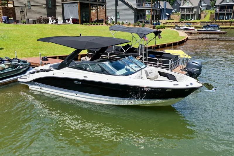 Slide: The Image of 2025 Sea Ray SLX 280 boat docked on a sunny lakeside. - 5