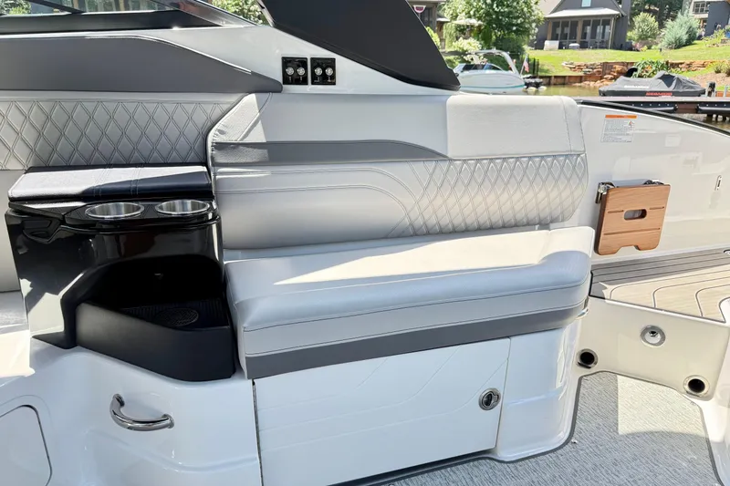 Slide: The Image of Luxurious interior seating of 2025 Sea Ray SLX 280 boat with cup holders and elegant design. - 28