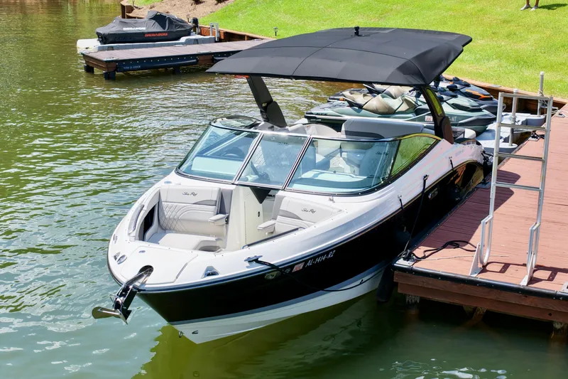 Slide: The Image of 2025 Sea Ray SLX 280 boat docked on a sunny day, featuring sleek design and spacious seating. - 6