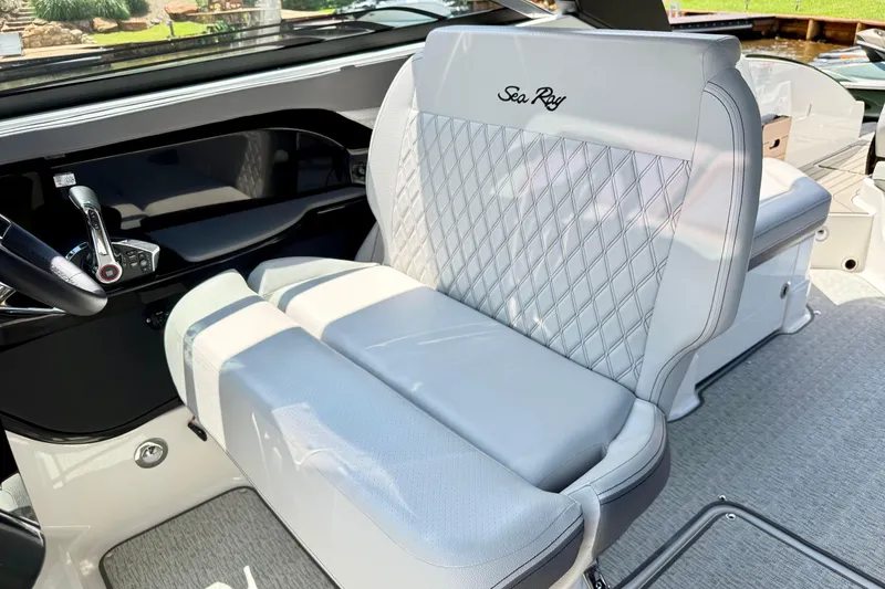 Slide: The Image of 2025 Sea Ray SLX 280 boat interior with luxurious seating and modern controls. - 13