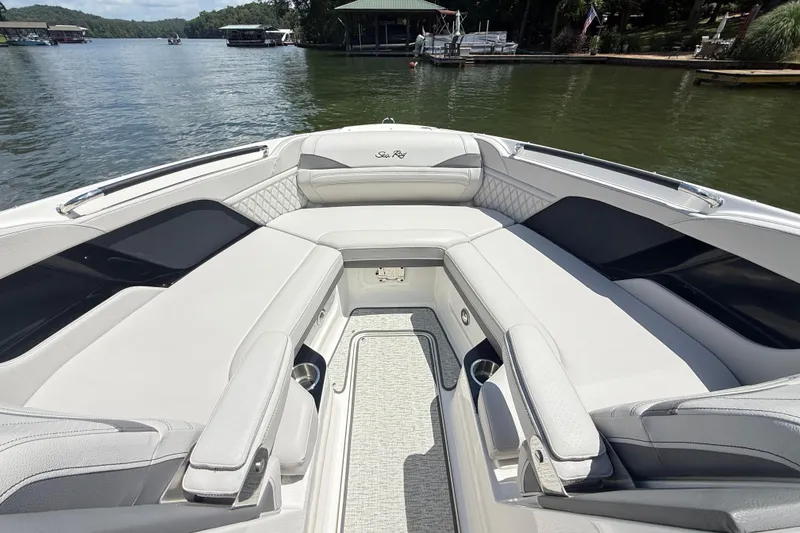 Slide: The Image of 2025 Sea Ray SLX 280 boat interior with luxurious seating on a serene lake. - 20