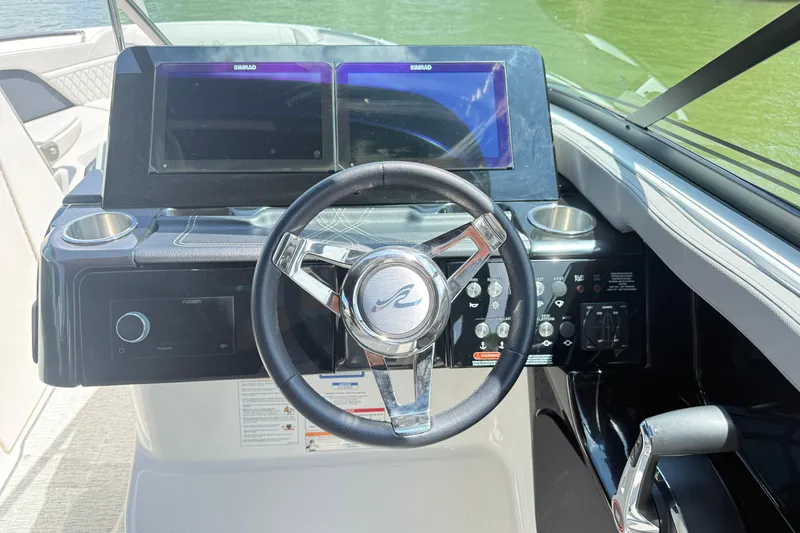 Slide: The Image of 2025 Sea Ray SLX 280 helm with dual Simrad displays and modern controls. - 15