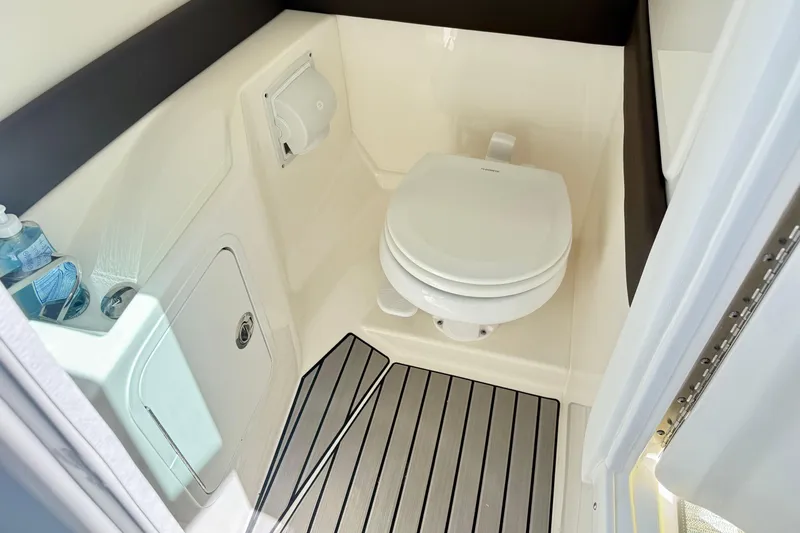 Slide: The Image of 2025 Sea Ray SLX 280 boat bathroom with modern toilet and sleek design. - 19