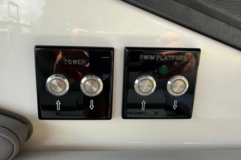 Slide: The Image of Control panel of 2025 Sea Ray SLX 280 with tower and swim platform buttons. - 29