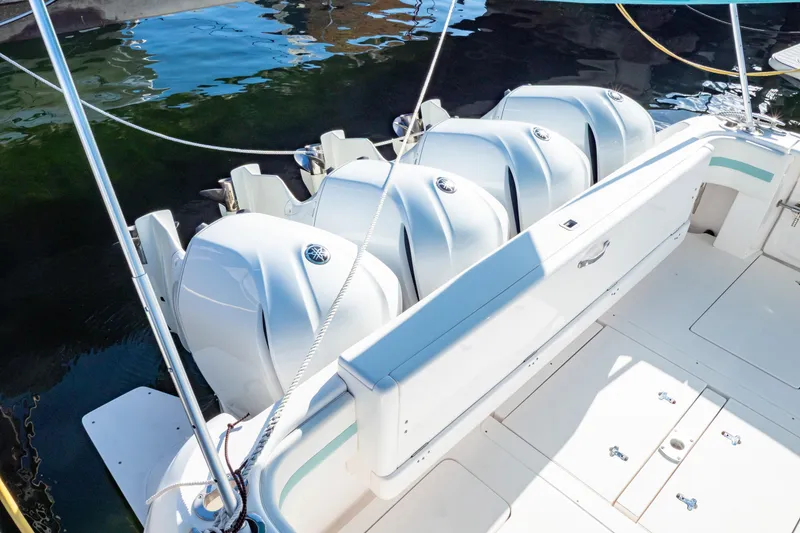 Slide: The Image of 2018 Intrepid 475 Sport Yacht with multiple outboard engines, docked on calm water. - 38