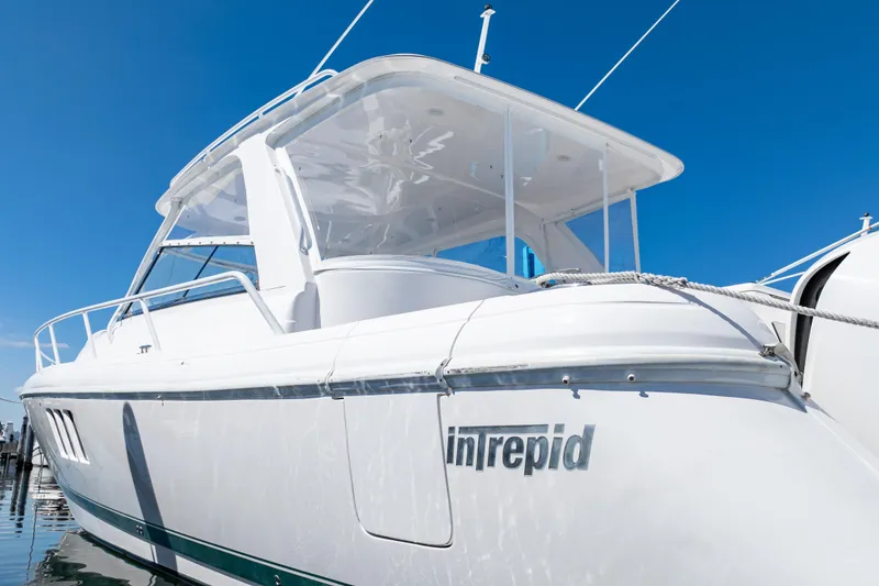 Slide: The Image of 2018 Intrepid 475 Sport Yacht with sleek design against clear blue sky. - 27