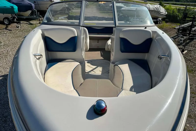 Slide: The Image of 2006 Tahoe Q6 Sport boat with spacious seating and sleek design in a sunny outdoor setting. - 7