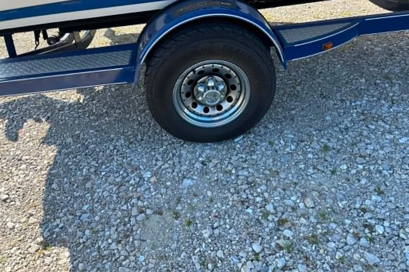 Slide: The Image of Trailer wheel of a 2006 Tahoe Q6 Sport on gravel surface. - 11