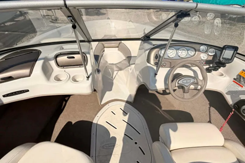 Slide: The Image of Interior of a 2006 Tahoe Q6 Sport boat, featuring steering wheel and dashboard controls. - 2