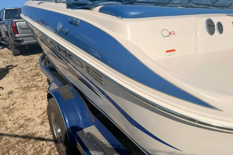 Slide: The Image of 2006 Tahoe Q6 Sport boat with blue and white design on trailer. - 8