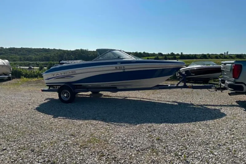 Slide: The Image of 2006 Tahoe Q6 Sport boat on trailer in sunny outdoor setting. - 13
