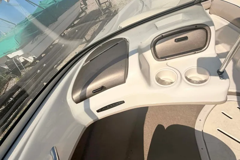 Slide: The Image of Interior of a 2006 Tahoe Q6 Sport boat with cup holders and storage compartments. - 12