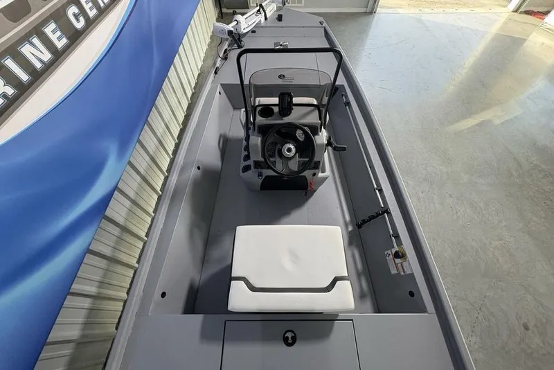 Slide: The Image of 2026 Tracker Bass Tracker Classic CC boat interior with steering console and seating. - 18
