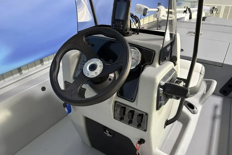 Slide: The Image of 2026 Tracker Bass Tracker Classic CC boat console with steering wheel and controls. - 12