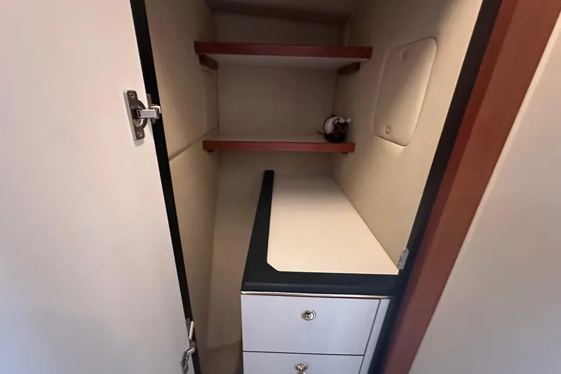 Slide: The Image of Interior storage space of 2001 Sea Ray 410 Sundancer yacht with shelves and drawers. - 14