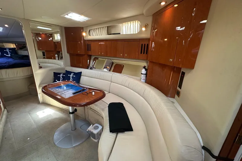 Slide: The Image of Luxurious interior of a 2001 Sea Ray 410 Sundancer yacht with elegant seating and wooden cabinetry. - 20