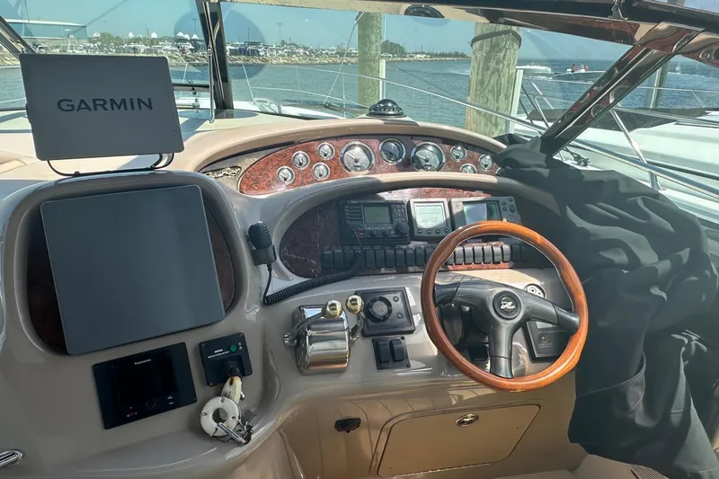 Slide: The Image of Cockpit of 2001 Sea Ray 410 Sundancer with Garmin navigation system and wooden steering wheel. - 7