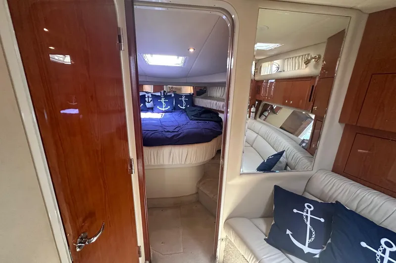 Slide: The Image of Interior of 2001 Sea Ray 410 Sundancer yacht with cozy cabin and nautical decor. - 11