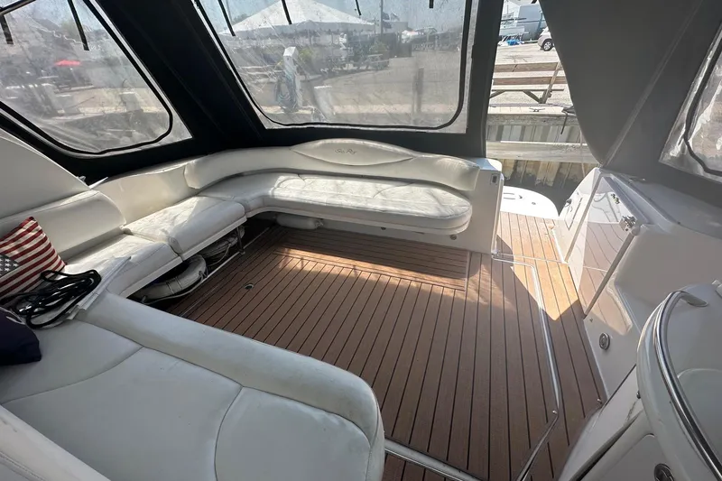 Slide: The Image of Luxurious 2001 Sea Ray 410 Sundancer yacht interior with white seating and wooden flooring. - 2