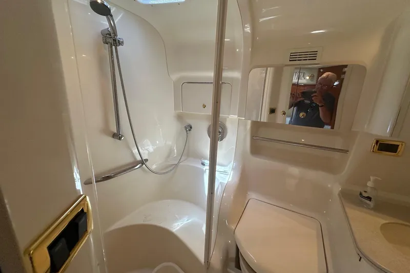 Slide: The Image of Bathroom interior of 2001 Sea Ray 410 Sundancer yacht, featuring shower and vanity. - 19